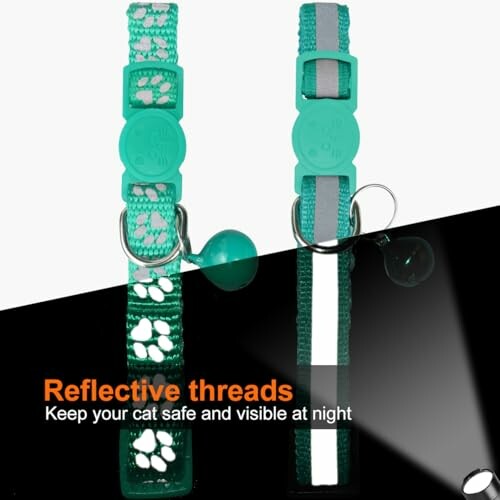 Two green reflective cat collars with paw prints and a bell.